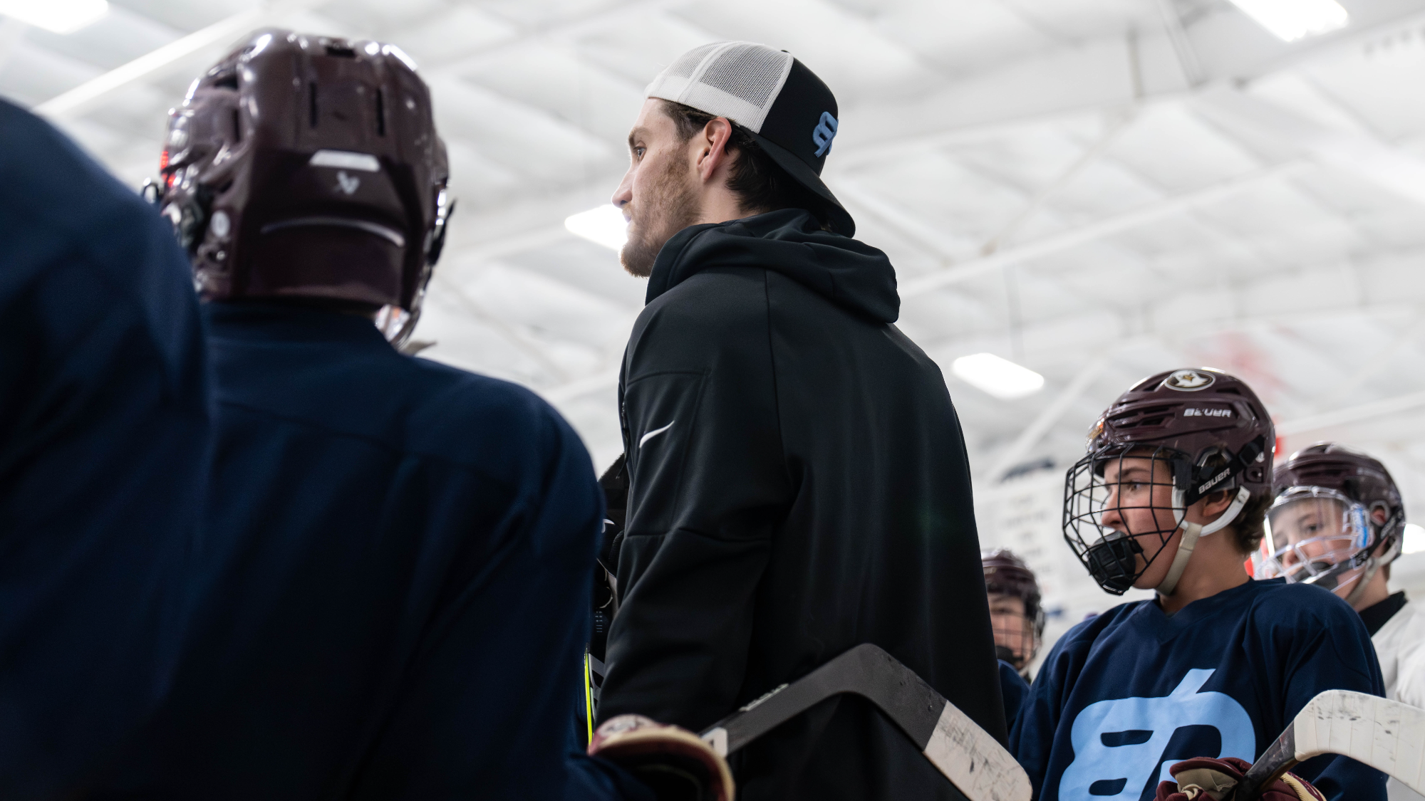 Coach reviewing play with players